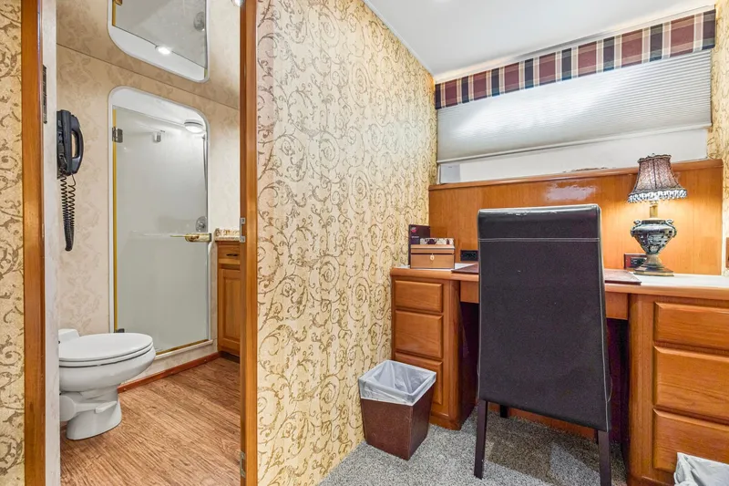  Yacht Photos Pics Interior of 1998 Viking 72 Enclosed Bridge yacht with desk, chair, and bathroom.