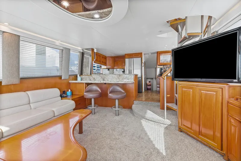  Yacht Photos Pics Luxurious interior of 1998 Viking 72 Enclosed Bridge yacht with modern kitchen and seating area.