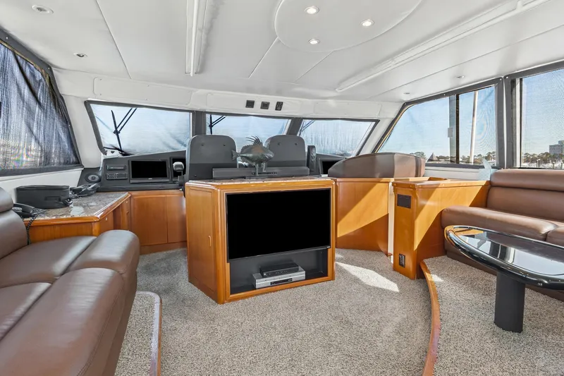  Yacht Photos Pics Luxurious interior of 1998 Viking 72 Enclosed Bridge yacht with leather seating and modern amenities.