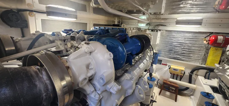 Laura K Yacht Photos Pics Engine room of a 2004 Cabo 48 Convertible yacht, showcasing a powerful marine engine.