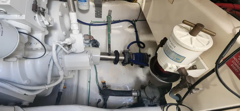 Laura K Yacht Photos Pics Engine room of a 2004 Cabo 48 Convertible boat, showcasing mechanical components and systems.