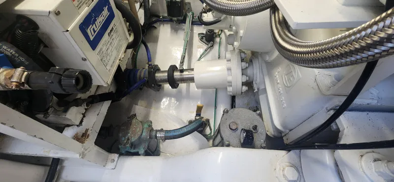 Laura K Yacht Photos Pics Engine room of 2004 Cabo 48 Convertible boat, showcasing mechanical components and wiring.