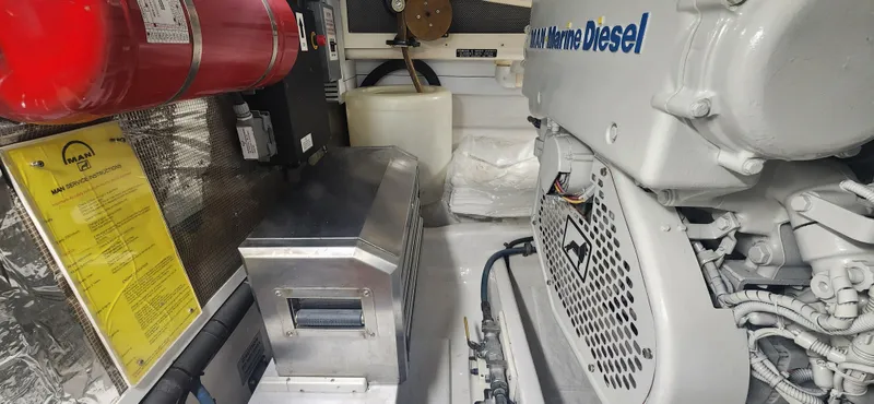 Laura K Yacht Photos Pics Engine room of 2004 Cabo 48 Convertible with marine diesel engine and safety equipment.