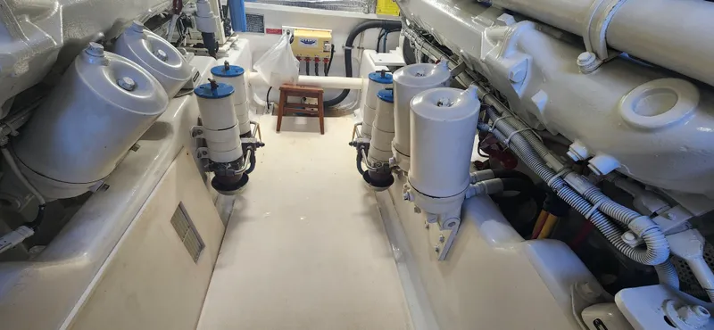 Laura K Yacht Photos Pics Engine room of 2004 Cabo 48 Convertible yacht, showcasing mechanical components and systems.