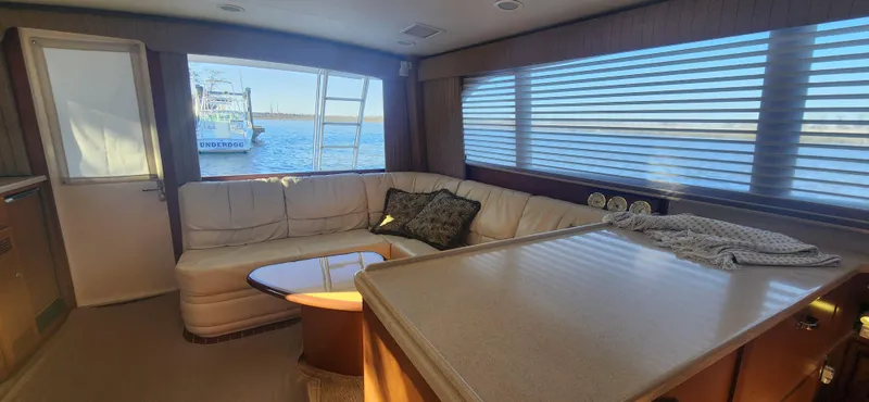 Laura K Yacht Photos Pics Luxurious interior of a 2004 Cabo 48 Convertible yacht with plush seating and ocean view.