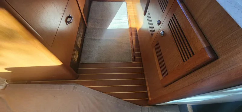 Laura K Yacht Photos Pics Interior of 2004 Cabo 48 Convertible yacht with wooden cabinetry and flooring.