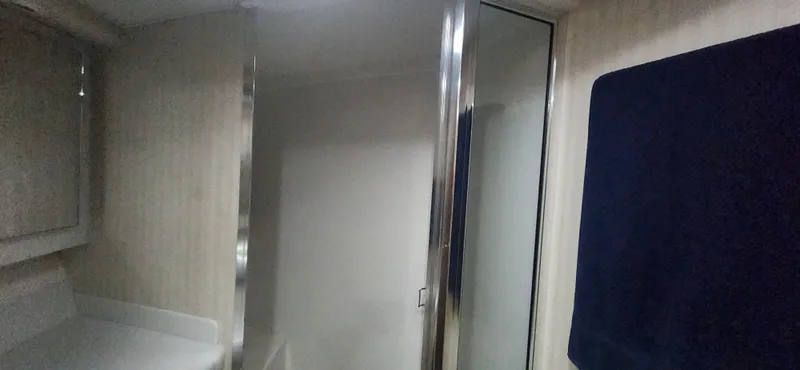 Laura K Yacht Photos Pics Interior of 2004 Cabo 48 Convertible yacht bathroom with mirror and towel.