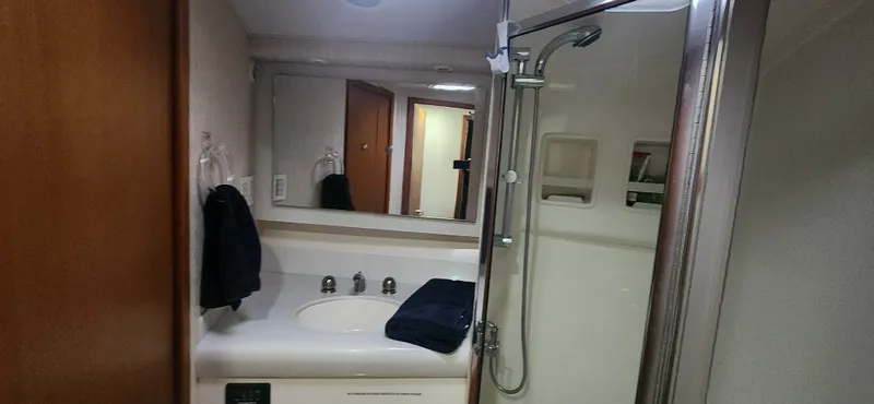 Laura K Yacht Photos Pics Bathroom interior of 2004 Cabo 48 Convertible yacht with shower and sink.
