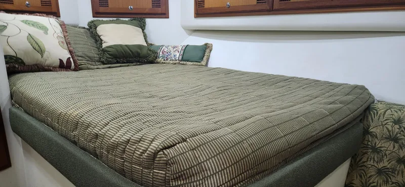 Laura K Yacht Photos Pics 2004 Cabo 48 Convertible cabin with cozy bed and decorative pillows.