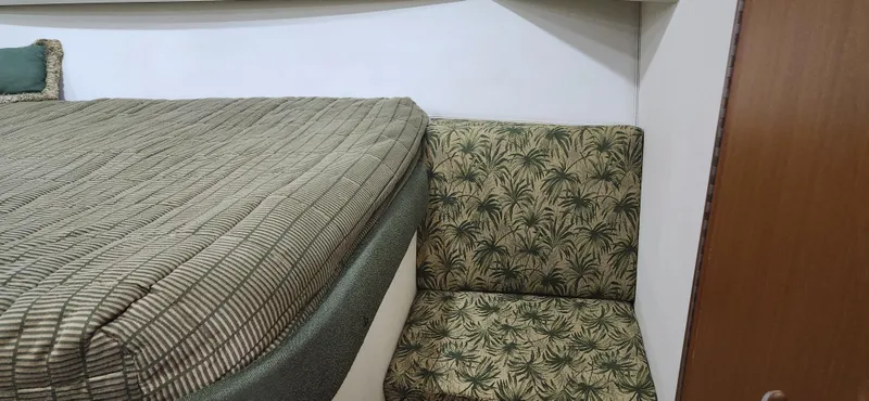 Laura K Yacht Photos Pics Interior of 2004 Cabo 48 Convertible with patterned upholstery and bedding.