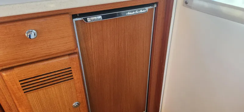 Laura K Yacht Photos Pics Wooden cabinet and refrigerator door inside a 2004 Cabo 48 Convertible yacht.