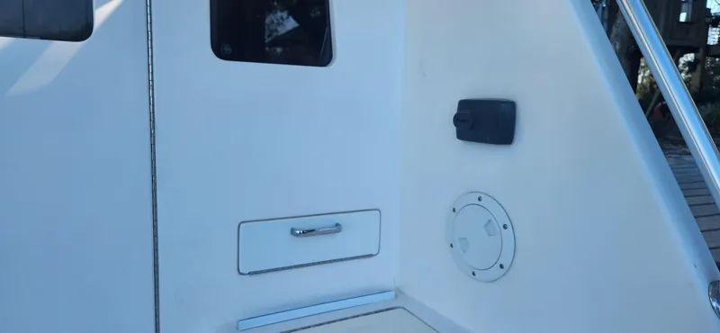 Laura K Yacht Photos Pics 2004 Cabo 48 Convertible yacht interior detail with storage compartment and window.