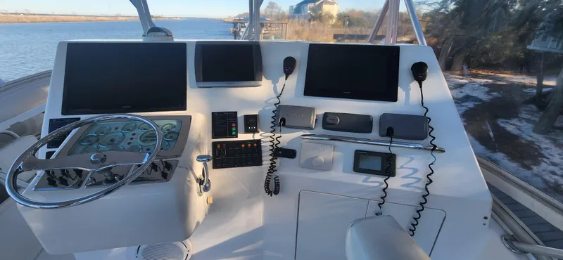 Laura K Yacht Photos Pics 2004 Cabo 48 Convertible yacht helm with navigation screens and controls.