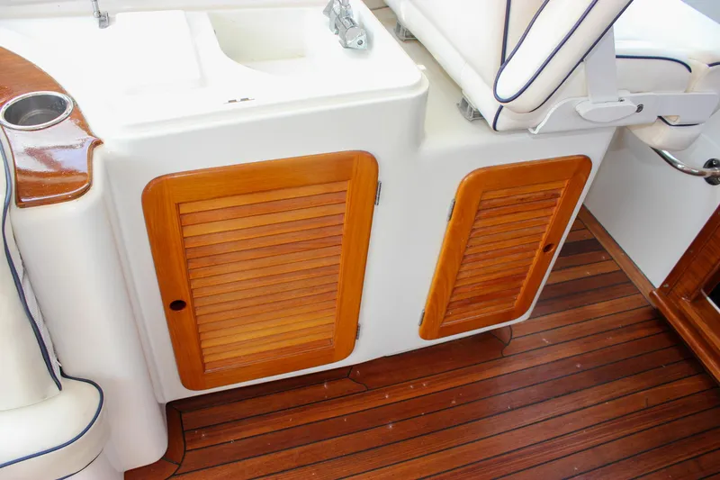 Sunny Daze Yacht Photos Pics 2008 Hinckley Talaria 38R Convertible interior with wooden cabinets and seating.