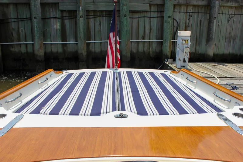 Sunny Daze Yacht Photos Pics 2008 Hinckley Talaria 38R Convertible boat with striped deck cushions and American flag.
