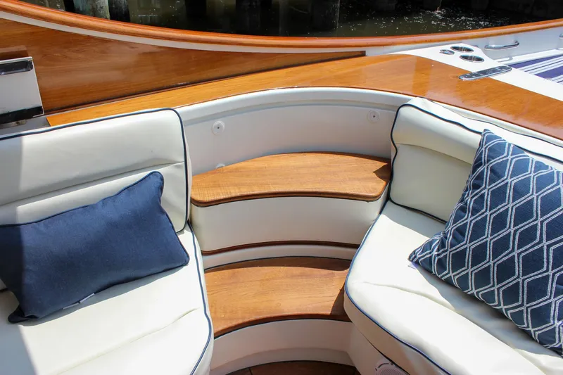 Sunny Daze Yacht Photos Pics Luxury seating area on 2008 Hinckley Talaria 38R Convertible with elegant cushions and wood accents.