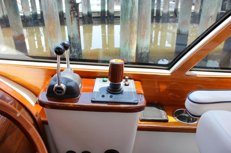 Sunny Daze Yacht Photos Pics Control panel of a 2008 Hinckley Talaria 38R Convertible yacht with wooden accents.