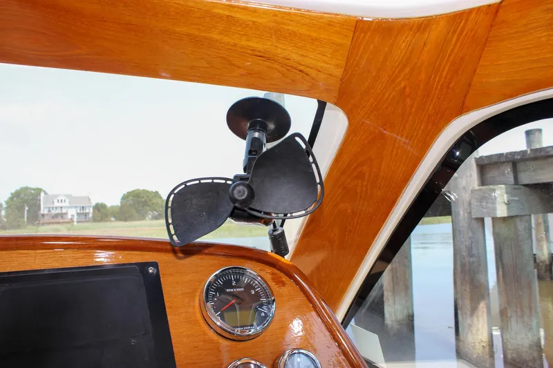 Sunny Daze Yacht Photos Pics Interior of 2008 Hinckley Talaria 38R Convertible with wooden dashboard and fan.