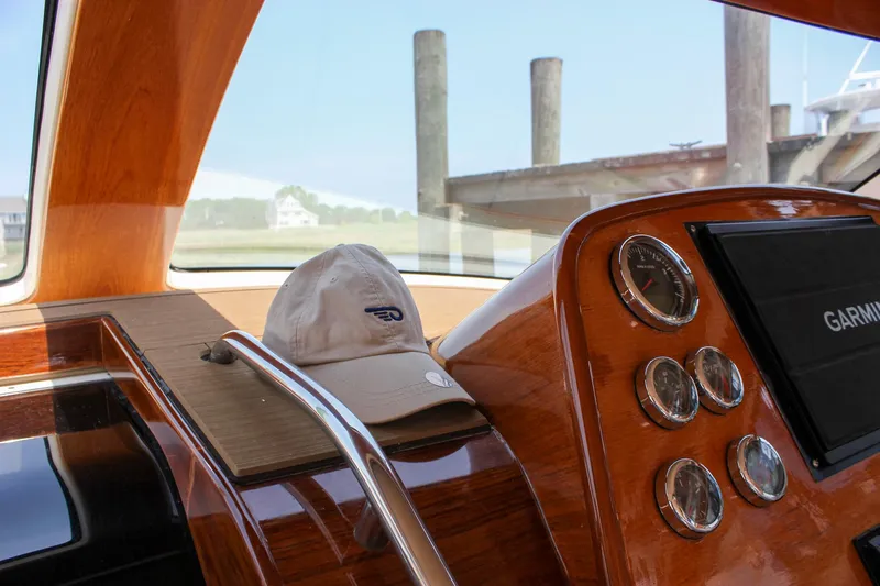 Sunny Daze Yacht Photos Pics Interior of 2008 Hinckley Talaria 38R Convertible with wooden dashboard and gauges.