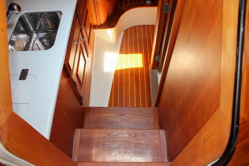 Sunny Daze Yacht Photos Pics Interior of 2008 Hinckley Talaria 38R Convertible, featuring wooden stairs and cabinetry.