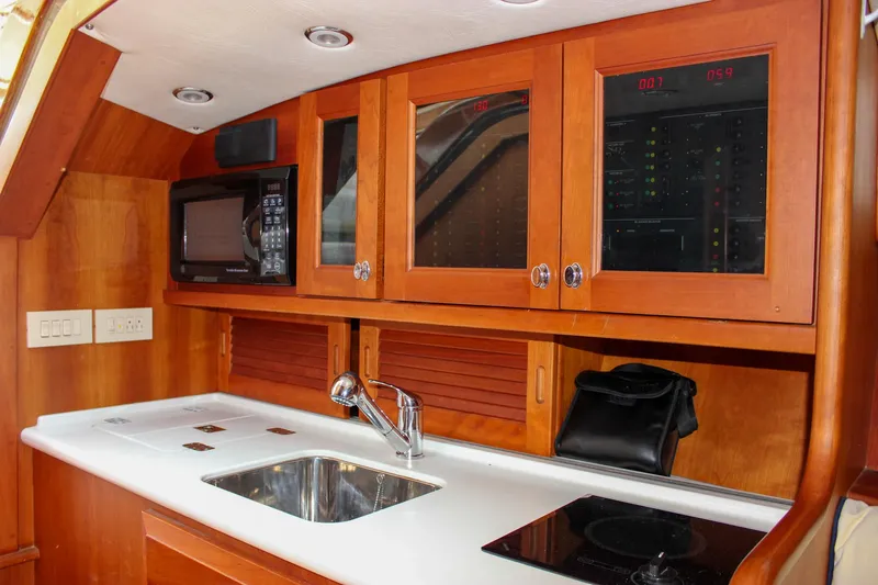 Sunny Daze Yacht Photos Pics Interior of 2008 Hinckley Talaria 38R Convertible yacht kitchen with sink and microwave.