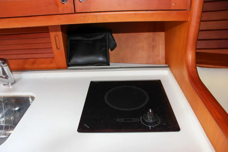 Sunny Daze Yacht Photos Pics Hinckley Talaria 38R Convertible 2008 yacht interior with stove and sink.