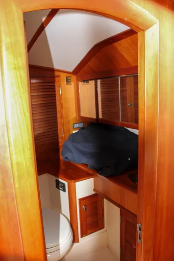 Sunny Daze Yacht Photos Pics Interior of 2008 Hinckley Talaria 38R Convertible, featuring wooden cabinetry and compact bathroom.