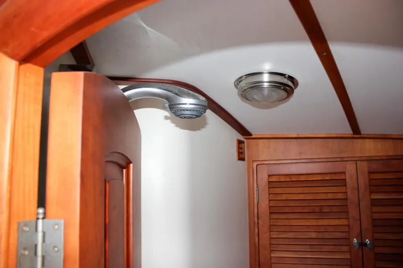 Sunny Daze Yacht Photos Pics Interior of 2008 Hinckley Talaria 38R Convertible, featuring wooden cabinetry and ceiling light.