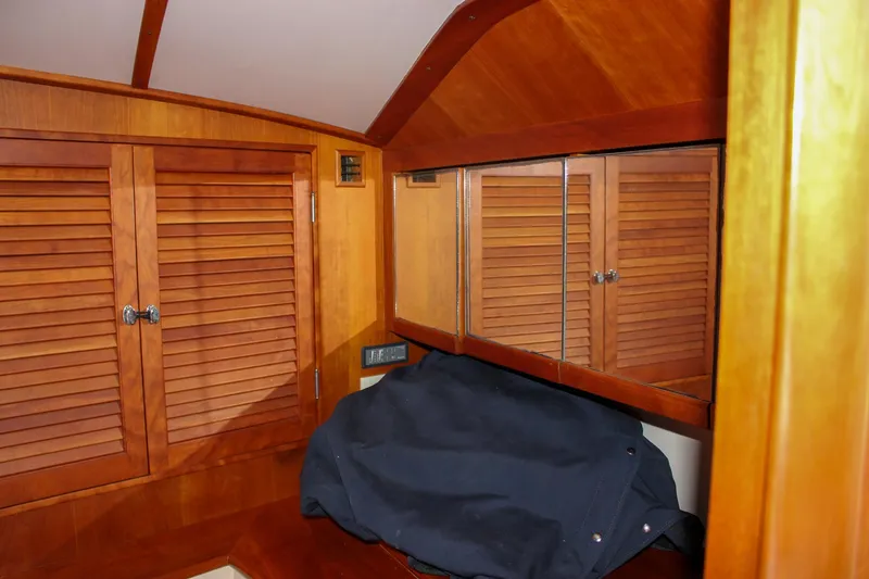 Sunny Daze Yacht Photos Pics Interior of 2008 Hinckley Talaria 38R Convertible with wooden cabinetry and mirrored surfaces.