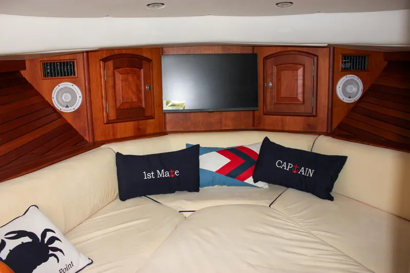 Sunny Daze Yacht Photos Pics Interior of 2008 Hinckley Talaria 38R Convertible with cozy seating and nautical-themed pillows.