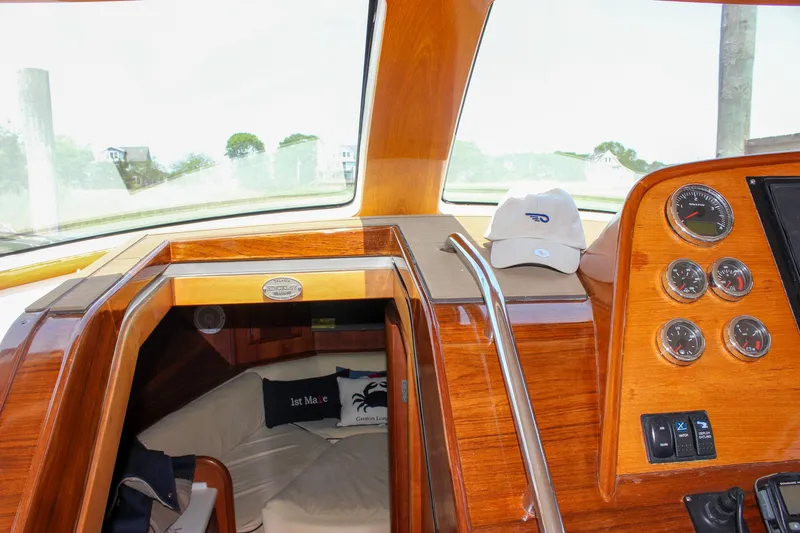 Sunny Daze Yacht Photos Pics Interior of 2008 Hinckley Talaria 38R Convertible with wooden dashboard and gauges.