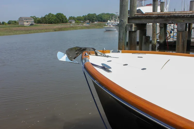 Sunny Daze Yacht Photos Pics 2008 Hinckley Talaria 38R Convertible docked by a serene waterfront.