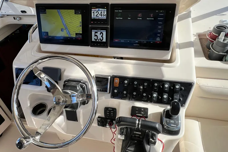 Reel E Blessed Yacht Photos Pics Control panel of 2017 Grady-White Express 330 boat with navigation screens and steering wheel.