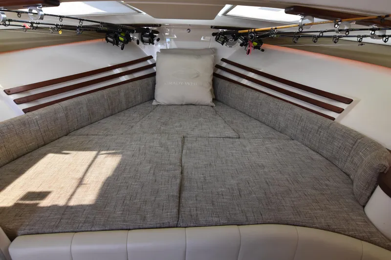 Reel E Blessed Yacht Photos Pics 2017 Grady-White Express 330 cabin interior with cushioned seating and fishing rods.