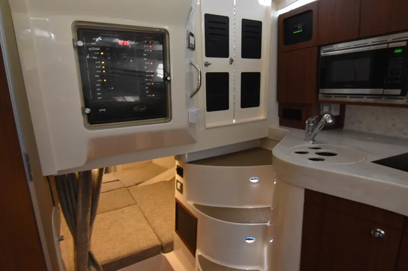 Reel E Blessed Yacht Photos Pics 2017 Grady-White Express 330 interior with kitchenette, control panel, and cozy seating area.