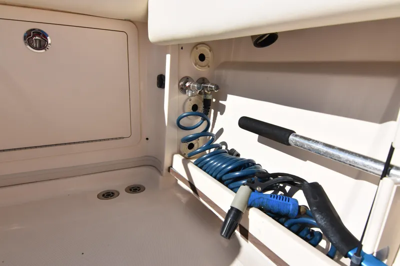 Reel E Blessed Yacht Photos Pics 2017 Grady-White Express 330 boat storage compartment with coiled hose and tools.
