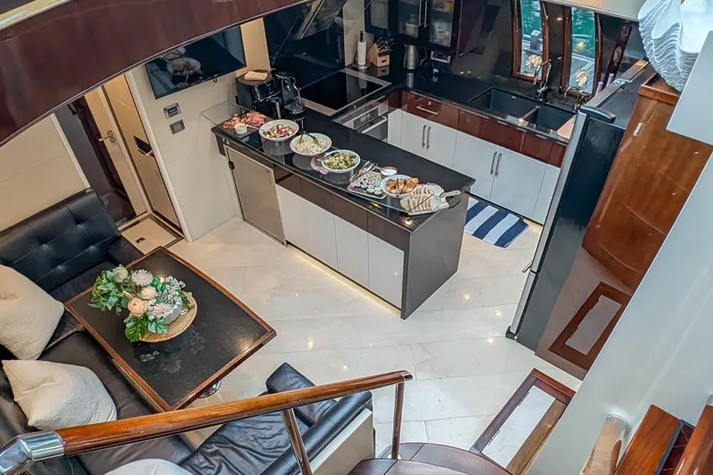 La Mar Yacht Photos Pics Luxurious 2012 Lazzara LSX 78 yacht interior with modern kitchen and dining area.