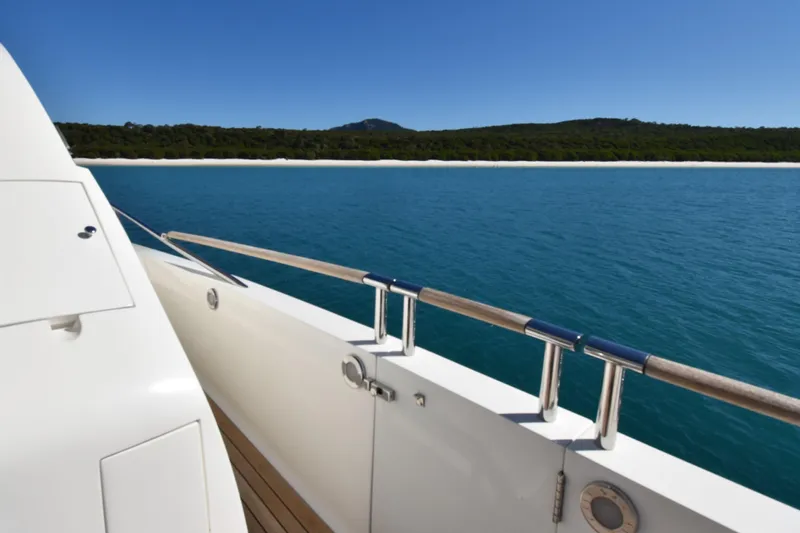 La Mar Yacht Photos Pics Lazzara LSX 78 yacht deck overlooking serene blue waters and distant shoreline, 2012 model.