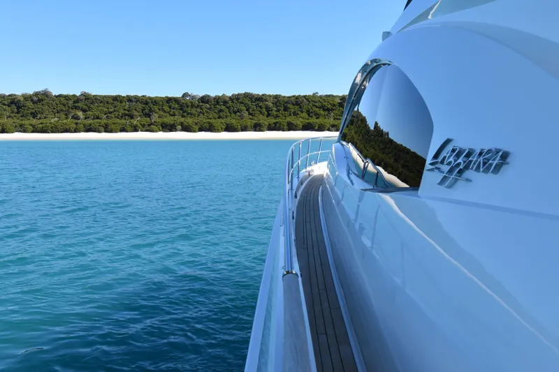 La Mar Yacht Photos Pics Luxury Lazzara LSX 78 yacht cruising near a scenic coastline, 2012 model.