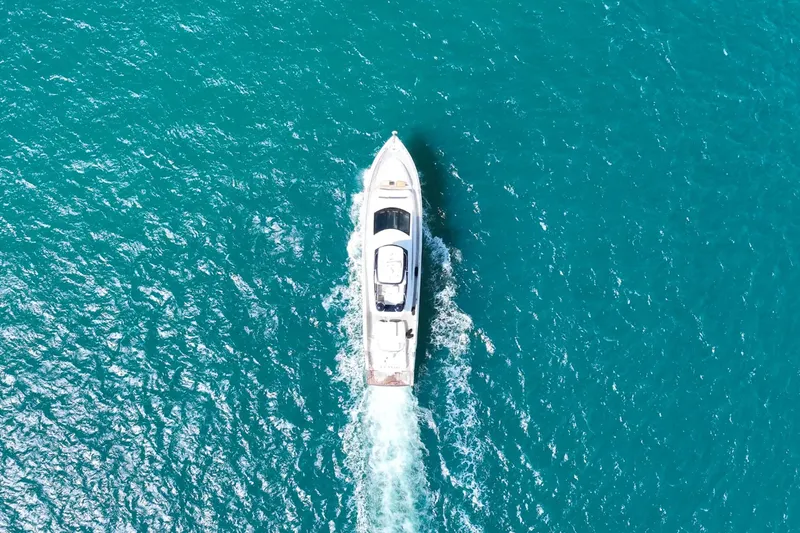 La Mar Yacht Photos Pics Aerial view of 2012 Lazzara LSX 78 yacht cruising on turquoise water.