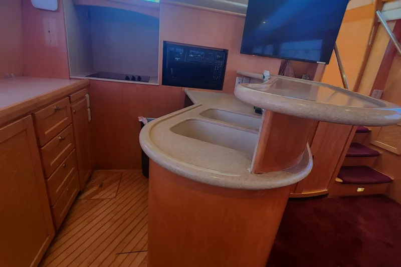  Yacht Photos Pics 1999 McKinna 57 Pilothouse interior with kitchen and bar area.