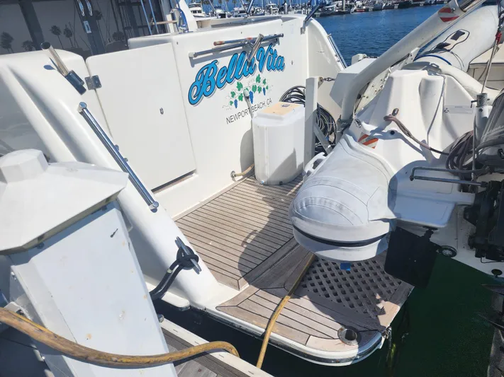  Yacht Photos Pics 1999 McKinna 57 Pilothouse yacht docked, featuring a small boat and deck equipment.