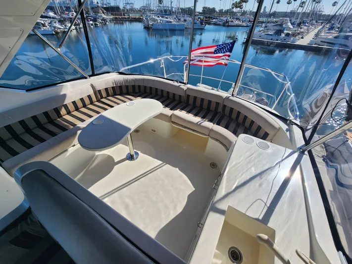  Yacht Photos Pics Luxurious 1999 McKinna 57 Pilothouse yacht with spacious seating and marina view.