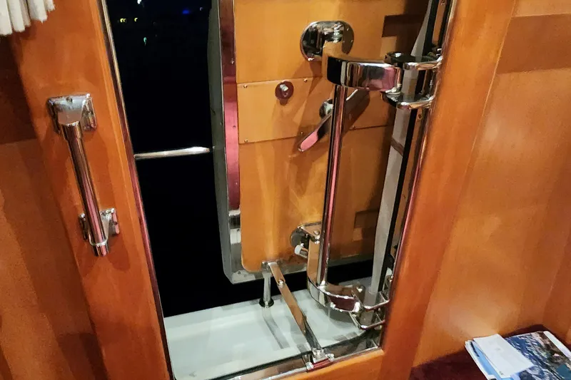  Yacht Photos Pics 1999 McKinna 57 Pilothouse interior door with chrome hardware and wooden finish.