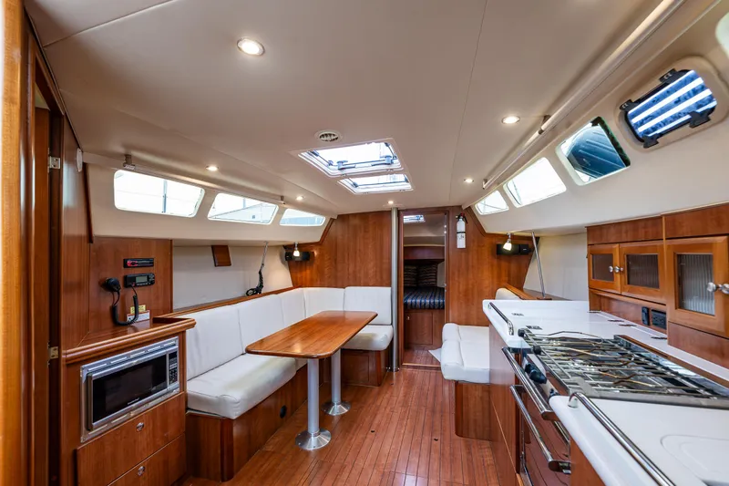  Yacht Photos Pics Interior of 2015 Marlow-Hunter 31 sailboat with modern kitchen and dining area.