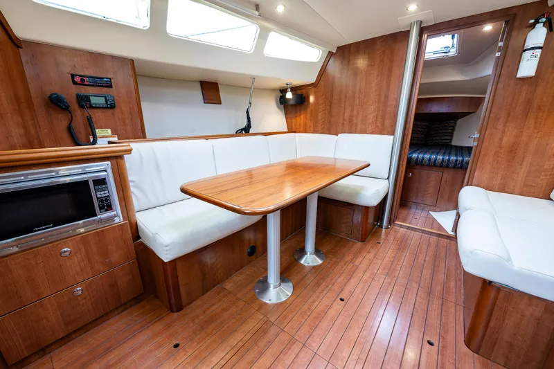  Yacht Photos Pics 2015 Marlow-Hunter 31 yacht interior with wood flooring, dining area, and modern amenities.