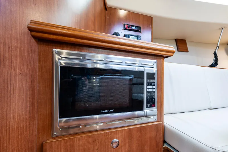  Yacht Photos Pics Interior of 2015 Marlow-Hunter 31 yacht featuring a built-in microwave and seating area.