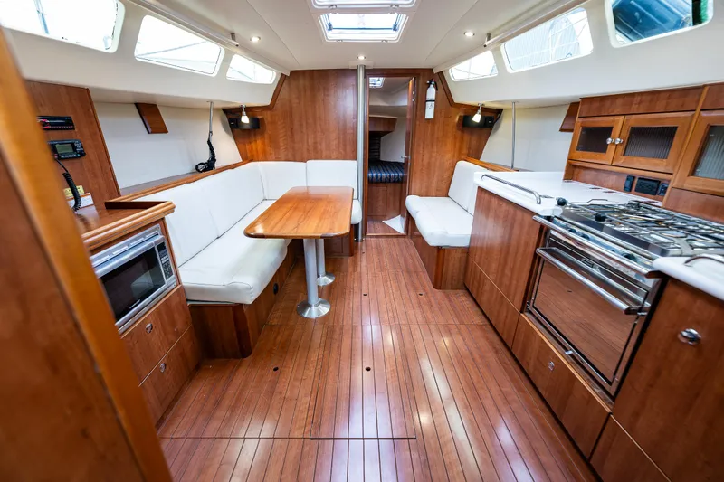  Yacht Photos Pics Interior of a 2015 Marlow-Hunter 31 sailboat with wood finish and modern amenities.