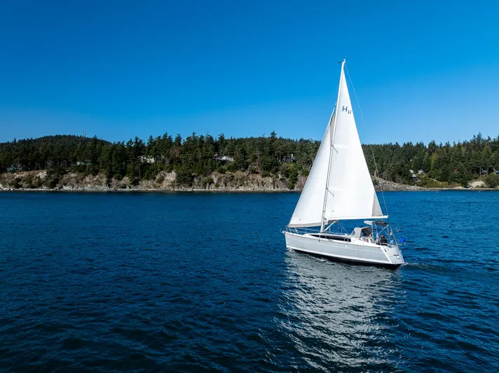  Yacht Photos Pics Sailboat Marlow-Hunter 31, 2015 model, cruising on a serene blue lake under clear skies.