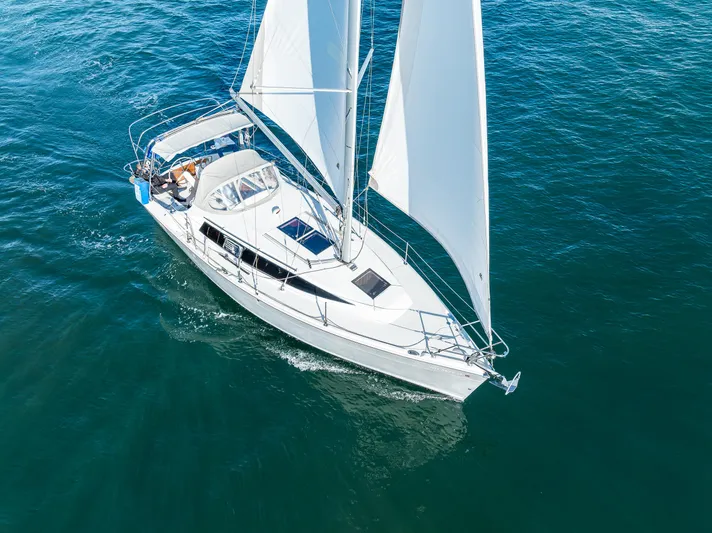  Yacht Photos Pics 2015 Marlow-Hunter 31 sailboat cruising on open water, aerial view.